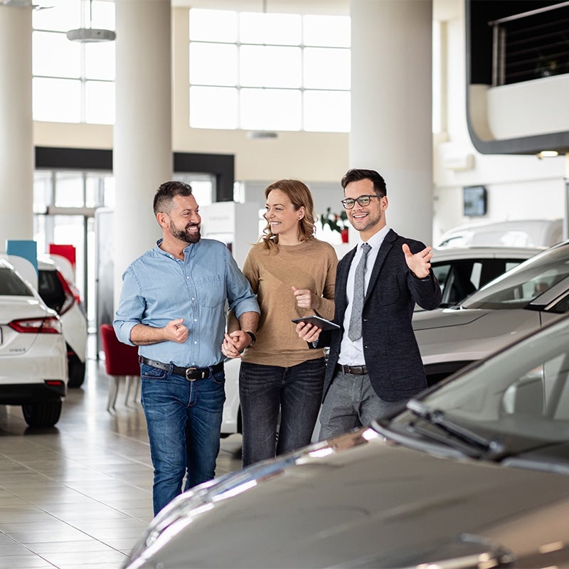 Salesman assisting a happy couple